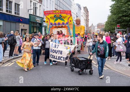 Jährliche Belfast Mela Carnival Parade - farbenfrohe Sehenswürdigkeiten und Geräusche auf der Royal Avenue, während die Parade zum Rathaus führt. Belfast, Großbritannien - 17. August 2024. Stockfoto