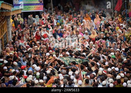 Srinagar, Indien. August 2024. Gläubige, die ein Tuch tragen, das als Chadar und Blumen bekannt ist, begeben sich am 17. August 2024 zum Schrein in Pakherpora, 43 Kilometer von Srinagar, Kaschmir, Indien, entfernt. Nach lokaler Tradition wurde Hazrat Sultan Sayed Muhammad Ali Balkhi als ein Nachfahre des Propheten Muhammad angesehen und regierte die Stadt Millahin Balkh, die im heutigen Afghanistan liegt. (Foto: Danish Showkat/SIPA USA.) Quelle: SIPA USA/Alamy Live News Stockfoto