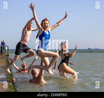 pic Shows: Wochenendreisende nehmen am letzten Morgen ein Bad im Walpole Bay Gezeitenbecken in Margate, Kent, bevor sie wieder zur Arbeit gehen. Heißes Wetter, Marga Stockfoto