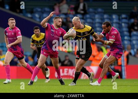 Joe Westerman von Castleford Tigers (Mitte) wird von Huddersfield Giants Leroy Cudjoe (rechts) während des Spiels der Betfred Super League in Elland Road, Leeds, besiegt. Bilddatum: Sonntag, 18. August 2024. Stockfoto