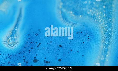 Feuchter Glitzer verschüttet. Bokeh-Licht. Defokussierte blaue Farbe schimmernde Partikel Schaum Textur Acrylfarbe Fluss abstrakte Kunst Hintergrund. Stockfoto