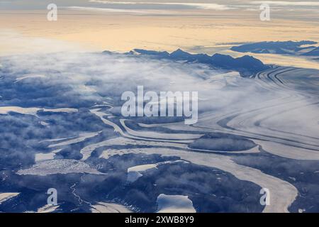 Aus der Vogelperspektive auf Gletscherzungen und Gletscher an der Küste mit spektakulären Bergen, Tasiilaq, Ostgrönland, Grönland Stockfoto