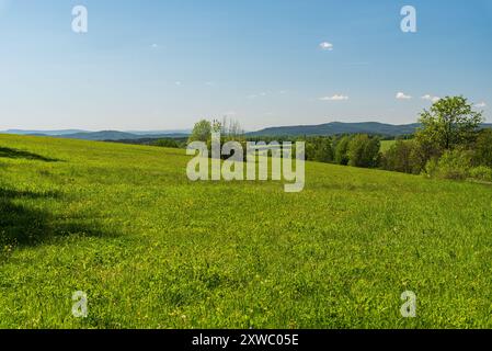 Westlicher Teil der Krusne hory Berge - Blick von der Straße über Luby Stadt in Tschechien am Frühlingstag mit blauem Himmel Stockfoto