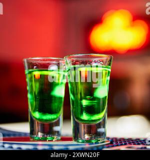 Grüner alkoholischer Drink in Schüssen an der Bar Stockfoto