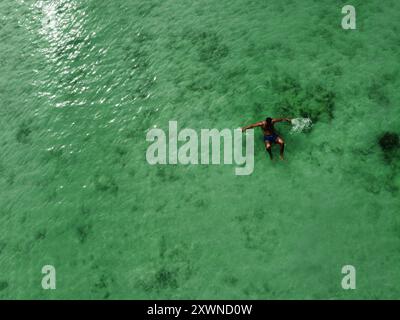 Aus der Vogelperspektive auf europäische Reisende, die im tropischen Wasser von Koh Kradan schwimmen und entspannen Stockfoto