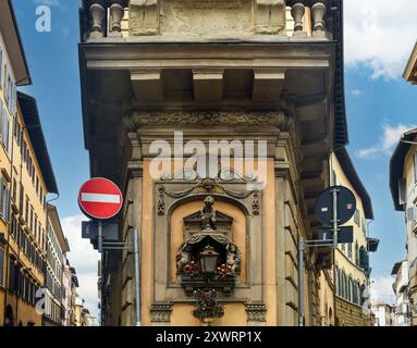 Ecke des Dudley Palace (1613) mit einem Tabernakel der Madonna mit Kind, Blick auf die zentrale Via de Tornabuoni, Florenz, Toskana, Italien Stockfoto