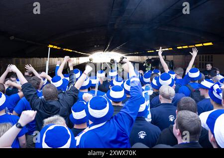 Eine große Gruppe von Hertha BSC-Fußballfans in Blau und weiß wird begeistert durch einen Tunnel in Richtung des Stadions in Hannover laufen sehen. Die Atmosphäre ist von Vorfreude und Spannung während dieser Veranstaltung 2011 erfüllt. Stockfoto