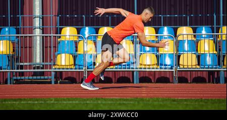 Der Läufer in Rot dreht sich um Geschwindigkeit und Leistung. sprinter läuft schneller zur Ziellinie, um den Sieg zu gewinnen. Stockfoto