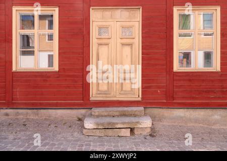 Gelbe Tür in einer roten Wand, Visby, Gotland, Schweden Stockfoto