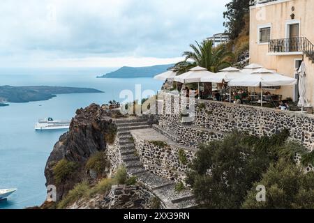 Santorini, Griechenland - 8. Oktober 2019: Von der ruhigen Terrasse aus bietet sich ein atemberaubender Blick auf die Ägäis. Stockfoto