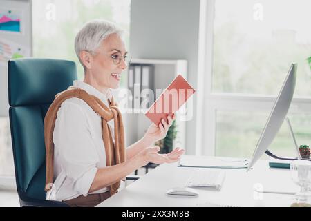 Foto von Smart älterer Chef weibliche Talk Online Konferenz Kleidung formalwear komfortabel modernes Büro Loft Raum innen Arbeitsplatz Stockfoto