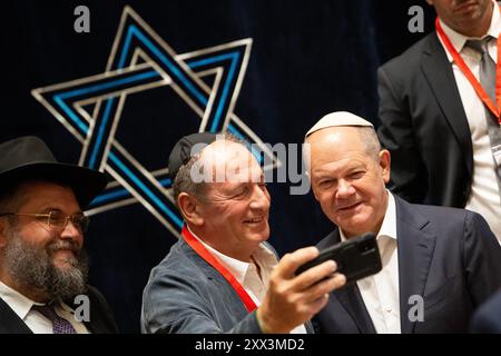 Potsdam, Deutschland. August 2024. Bundeskanzler Olaf Scholz (r, SPD) fotografiert in der Synagoge während eines Besuchs im Potsdamer Synagogenzentrum im Rahmen einer Sommerreise in seinen Wahlkreis mit Alexander Kogan, der ihm zuvor eine Esther-Schriftrolle für die Gemeinde überreichte. Quelle: Sebastian Gollnow/dpa/Alamy Live News Stockfoto