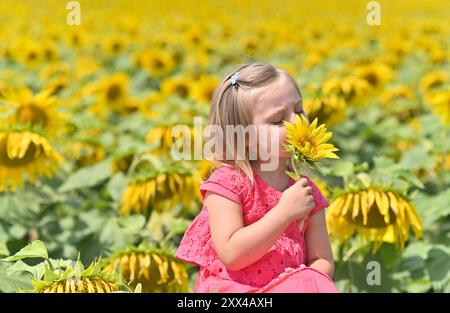 Porträt eines kleinen Mädchens mit einer Sonnenblume Stockfoto