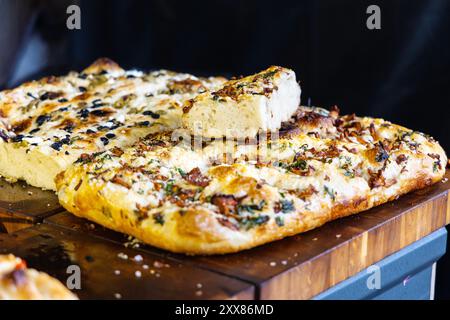 Focaccia mit Pfifferlingen und Parmesan auf dem Lebensmittelmarkt Nocny Market (Nachtmarkt) auf den ehemaligen Bahnsteigen des Hauptbahnhofs in Warschau, Polen Stockfoto