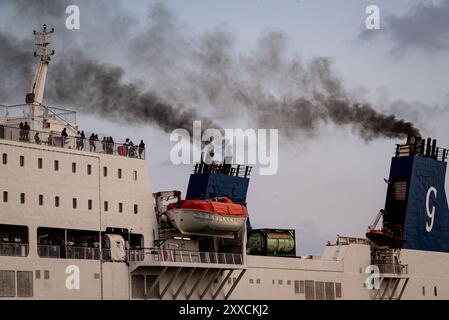 Die Schornsteine des Fährschiffs geben Rauch ab, während sie zum Hafen von Barcelona fahren. Schwefeldioxid- und Stickoxidemissionen machen den Hafen von Barcelona am schlechtesten Stockfoto