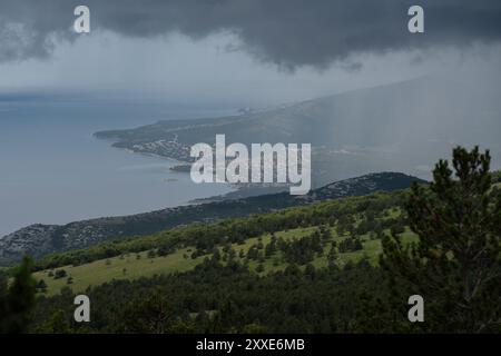 Dunkle Sturmwolken hängen bedrohlich über den kroatischen Bergen. Stockfoto