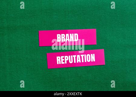Markenbotschaft auf rosafarbenem Papier mit grünem Hintergrund. Konzeptionelles Markenimage. Kopierbereich. Stockfoto