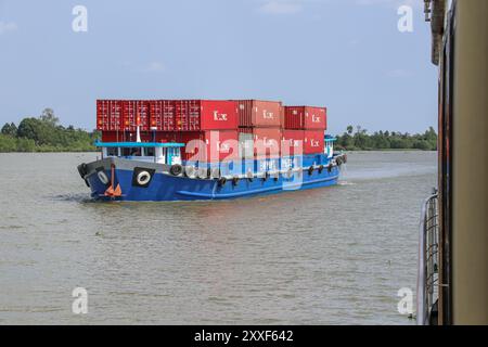 Mekong River, Vietnam/Cambodia. Aug 24,2024: Vietnamese container ship transports containers on the Asian waterway, one of Asia's biggest waterways. Maritime shipping freight transport is source of geopolitical tensions, environmental concerns & controversies as Cambodian PM plans to build Funan Techo canal (officially Tonle Bassac Navigation Road & Logistics System Project), a $1.7 billion China-backed project to connect Phnom Penh to Kampot seaport, diverting its goods for export directly to its own coast rather than via the Hanoi-controlled Mekong Delta. Credit: Kevin Izorce/Alamy Live News Stock Photo