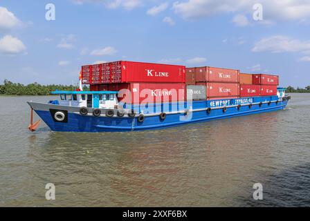 Mekong River, Vietnam/Cambodia. Aug 24,2024: Vietnamese container ship transports containers on the Asian waterway, one of Asia's biggest waterways. Maritime shipping freight transport is source of geopolitical tensions, environmental concerns & controversies as Cambodian PM plans to build Funan Techo canal (officially Tonle Bassac Navigation Road & Logistics System Project), a $1.7 billion China-backed project to connect Phnom Penh to Kampot seaport, diverting its goods for export directly to its own coast rather than via the Hanoi-controlled Mekong Delta. Credit: Kevin Izorce/Alamy Live News Stock Photo