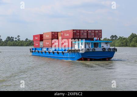 Mekong River, Vietnam/Cambodia. Aug 24,2024: Vietnamese container ship transports containers on the Asian waterway, one of Asia's biggest waterways. Maritime shipping freight transport is source of geopolitical tensions, environmental concerns & controversies as Cambodian PM plans to build Funan Techo canal (officially Tonle Bassac Navigation Road & Logistics System Project), a $1.7 billion China-backed project to connect Phnom Penh to Kampot seaport, diverting its goods for export directly to its own coast rather than via the Hanoi-controlled Mekong Delta. Credit: Kevin Izorce/Alamy Live News Stock Photo