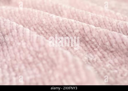 Textur aus rosa Strickstoff als Hintergrund, Nahaufnahme Stockfoto