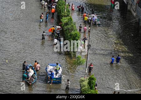 Dhaka, Bangladesh. 24th Aug, 2024. People wade through floodwater in Feni district in Chittagong division. Flood affected area in Feni district in Chittagong division, Bangladesh. Credit: SOPA Images Limited/Alamy Live News Stock Photo