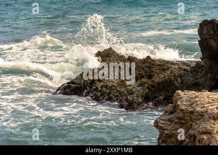Wellen gegen Felsen. Stockfoto