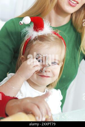 Zwei entzückenden Mädchen mit Mutter Backen Weihnachtsplätzchen in der Küche Stockfoto
