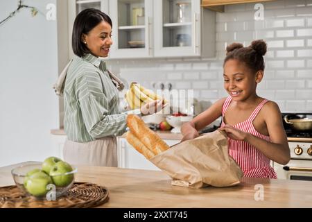 Ein afroamerikanisches Mädchen hilft Mutter beim Einkaufen Stockfoto