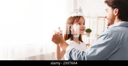 Kleine Prinzen tanzen mit ihrem Vater zu Hause Stockfoto