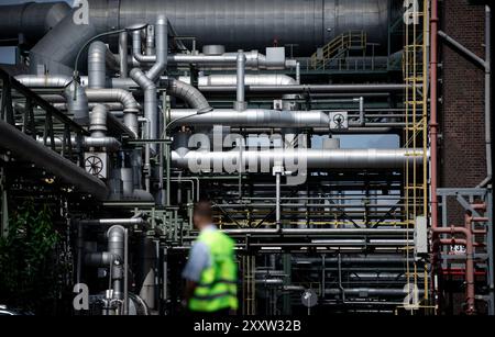 Marl, Deutschland. August 2024. Vor Rohren auf dem Gelände des Chemieparks Evonik steht ein Mitarbeiter der Werkssicherheit. Quelle: Fabian Strauch/dpa/Alamy Live News Stockfoto