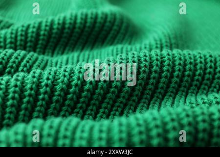 Textur von grünem Strickgewebe als Hintergrund, Nahaufnahme Stockfoto