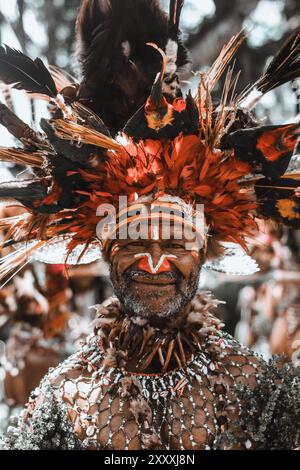 Ein älterer Dorflehrer aus den westlichen Highlands von Papua-Neuguinea in traditioneller Kleidung, die das reiche kulturelle Erbe seiner Gemeinde verkörpert. Stockfoto