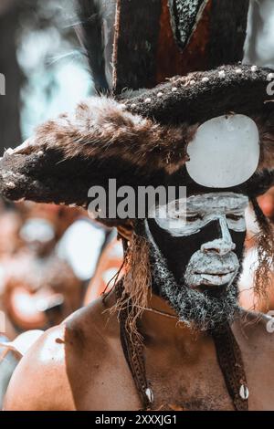 Ein Highlands-Mann in traditioneller Kleidung, der das reiche kulturelle Erbe Papua-Neuguineas mit lebhaften Farben und komplizierten Designs verkörpert. Stockfoto