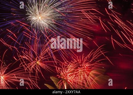 Leuchtendes Feuerwerk und Salut in verschiedenen Farben am Nachthimmel Stockfoto