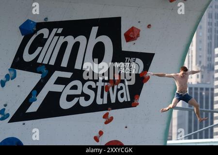 Brooklyn, Usa. August 2024. Beim North Face Climb Festival am Pier 5 im Brooklyn Bridge Park in New York City springt ein Kletterer ins Wasser. Die North Face Company veranstaltete ein Climb Festival im Brooklyn Bridge Park Credit: SOPA Images Limited/Alamy Live News Stockfoto