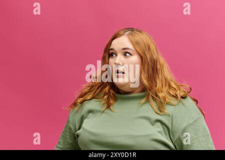 Eine Frau in einem grünen Pullover sieht überrascht zur Seite. Stockfoto