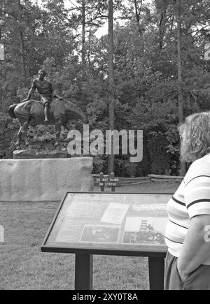 Kaukasische Touristen lesen Informationen an der Statue eines Jungen auf einem Pferd Monument im Andrew Jackson State Park, Lancaster, South Carolina, USA. Stockfoto