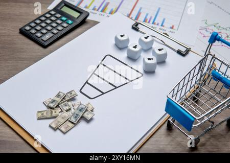 Eine Zwischenablage mit einem Verkaufstrichdiagramm und Würfeln, die Kunden repräsentieren. Geld und ein Einkaufswagen sind in der Nähe, was Umsätze und Umsätze symbolisiert. Stockfoto