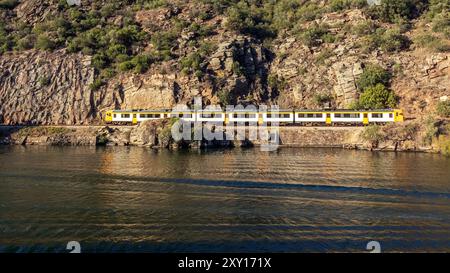 Zug am Ufer des Flusses Douro zwischen Pinhão und Peso da Régua in Portugal an einem sonnigen Herbsttag. Stockfoto