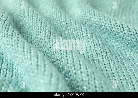 Textur aus türkisfarbenem Strickstoff als Hintergrund, Nahaufnahme Stockfoto