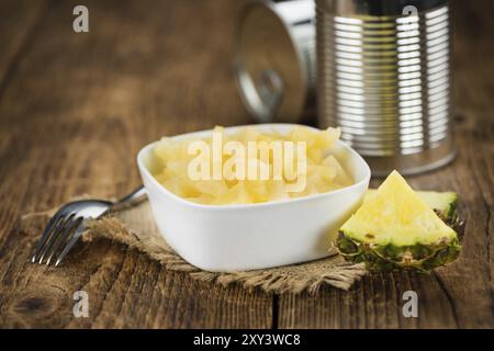 Frisch gemachte gehackte Ananas (konserviert) auf einem alten und rustikalen Holztisch, selektiver Fokus, Nahaufnahme Stockfoto