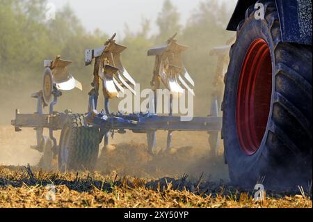 Pflug hinter einem Traktor Stockfoto