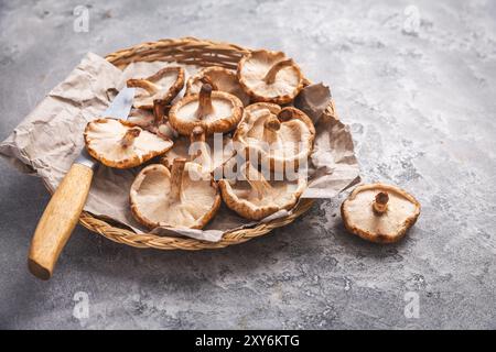 Bio-Shiitake-Pilze in einem Korb mit Messer Stockfoto
