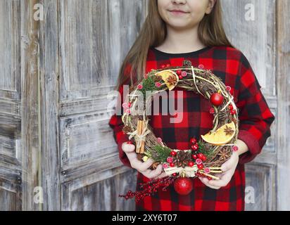 Weihnachten handgefertigte Kranz in jungen womans Hände. Winterurlaub feier Konzept Stockfoto