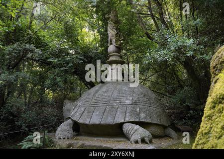 Rätselhafte weibliche Figur auf einer Schildkröte, Sacro Bosco, Heiliger Wald, Park der Monster, Parco dei Mostri, Groteske, monumentale Skulpturen, antike Bogen Stockfoto