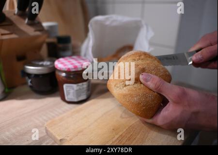 Berlin, Deutschland. Juli 2024. In der Küche wird ein Brötchen geschnitten. Brötchen; Küche; Credit: Alicia Windzio/dpa/Alamy Live News Stockfoto