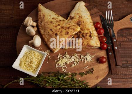 Calzone, traditionelle italienische Zubereitung, begleitet von Gewürzen und Rotwein Stockfoto