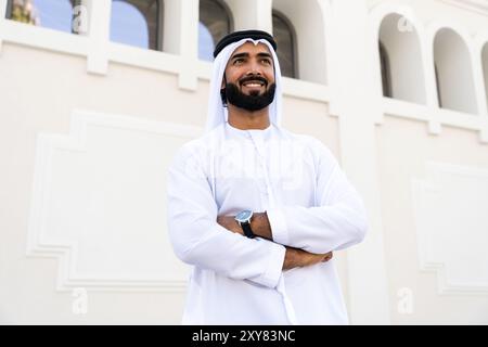 Traditioneller arabischer Mann, der im Freien emirat Kandura trägt - hübsches männliches Geschäftsmann-Porträt aus dem Nahen Osten in der Stadt Stockfoto