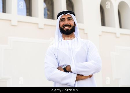 Traditioneller arabischer Mann, der im Freien emirat Kandura trägt - hübsches männliches Geschäftsmann-Porträt aus dem Nahen Osten in der Stadt Stockfoto